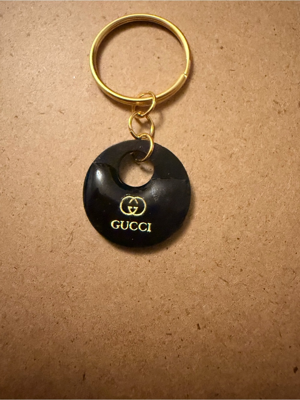 Gucci Black and Gold Round Logo Keyring